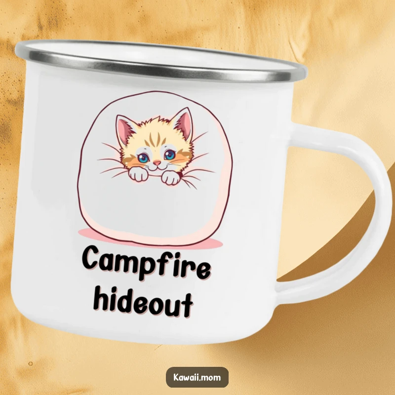 Funny kitten camping mug featuring a playful cat peeking from behind a cushion, designed for outdoor fun with humor.