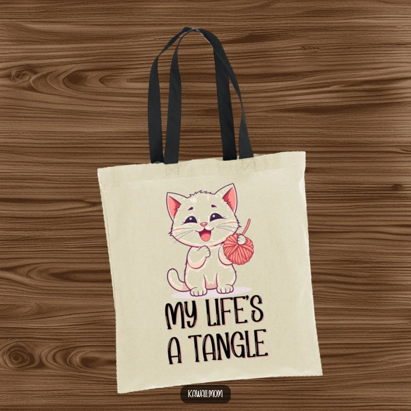 Funny Tote Bag: A happy kitten character engrossed in batting a dangling ball of yarn, a delightful and practical accessory.